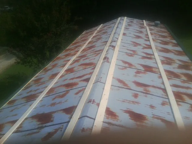 Rusted metal roof panels with new wood purlins before replacement — Storm Damage Roof Repair in Bear River City by Roofing Brothers